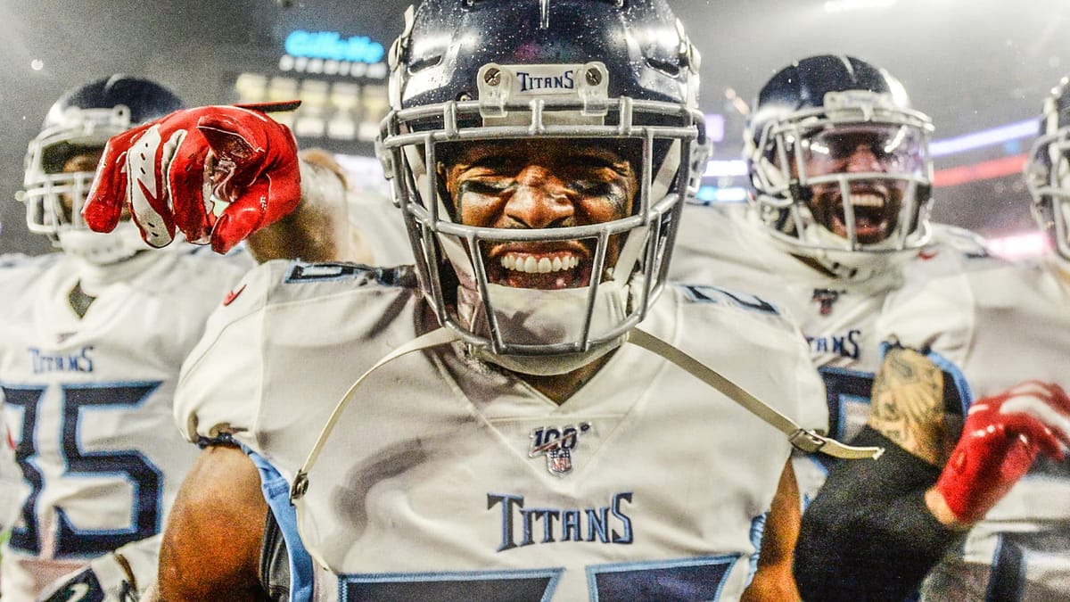 FOXBOROUGH, MASSACHUSETTS - JANUARY 04: Logan Ryan #26 of the Tennessee Titans celebrates his touchdown with teammates against the New England Patriots in the fourth quarter of the AFC Wild Card Playoff game at Gillette Stadium on January 04, 2020 in Foxborough, Massachusetts.