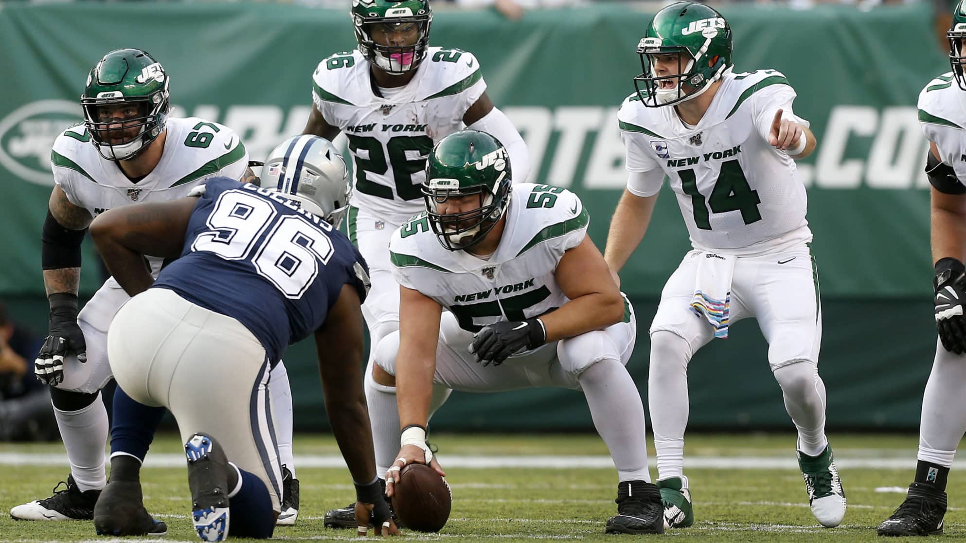EAST RUTHERFORD, NEW JERSEY - OCTOBER 13: (NEW YORK DAILIES OUT) Sam Darnold #14 and Ryan Kalil #55 of the New York Jets in action against the Dallas Cowboys at MetLife Stadium on October 13, 2019 in East Rutherford, New Jersey. The Jets defeated the Cowboys 24-22.