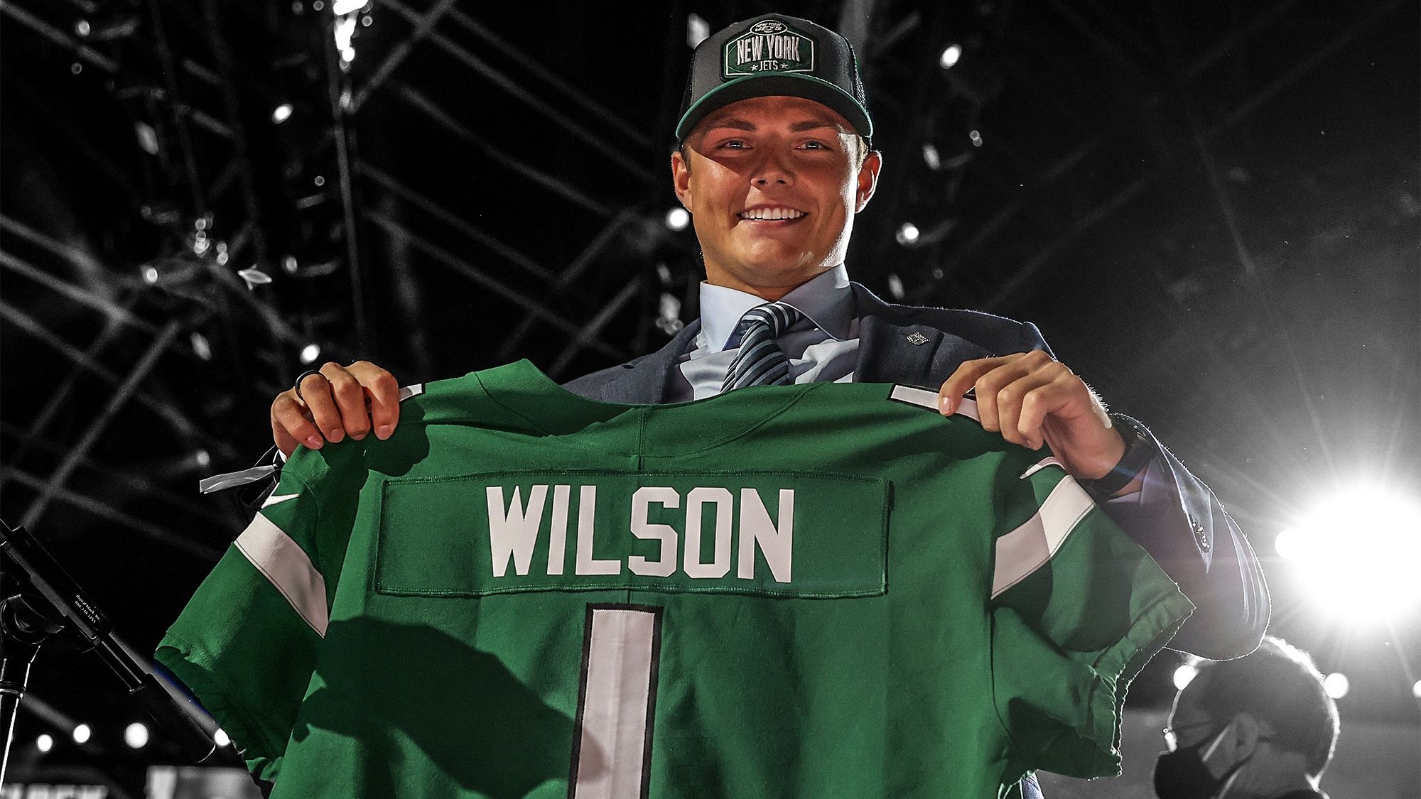 CLEVELAND, OHIO - APRIL 29: Zach Wilson holds a jersey onstage after being drafted second by the New York Jets during round one of the 2021 NFL Draft at the Great Lakes Science Center on April 29, 2021 in Cleveland, Ohio.