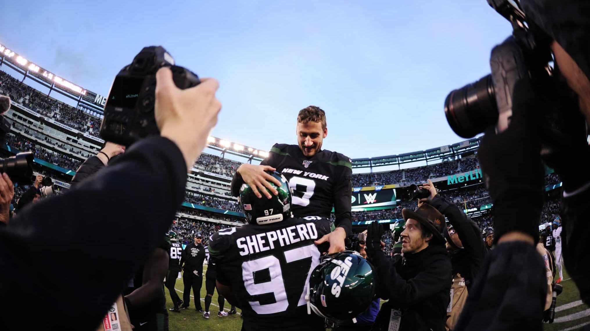 EAST RUTHERFORD, NEW JERSEY - DECEMBER 08: Nathan Shepherd #97 of the New York Jets lifts up Sam Ficken #9 after Ficken's game-winning field goal during the second half of the game against the Miami Dolphins at MetLife Stadium on December 08, 2019 in East Rutherford, New Jersey. The New York Jets defeat the Miami Dolphins 22-21.