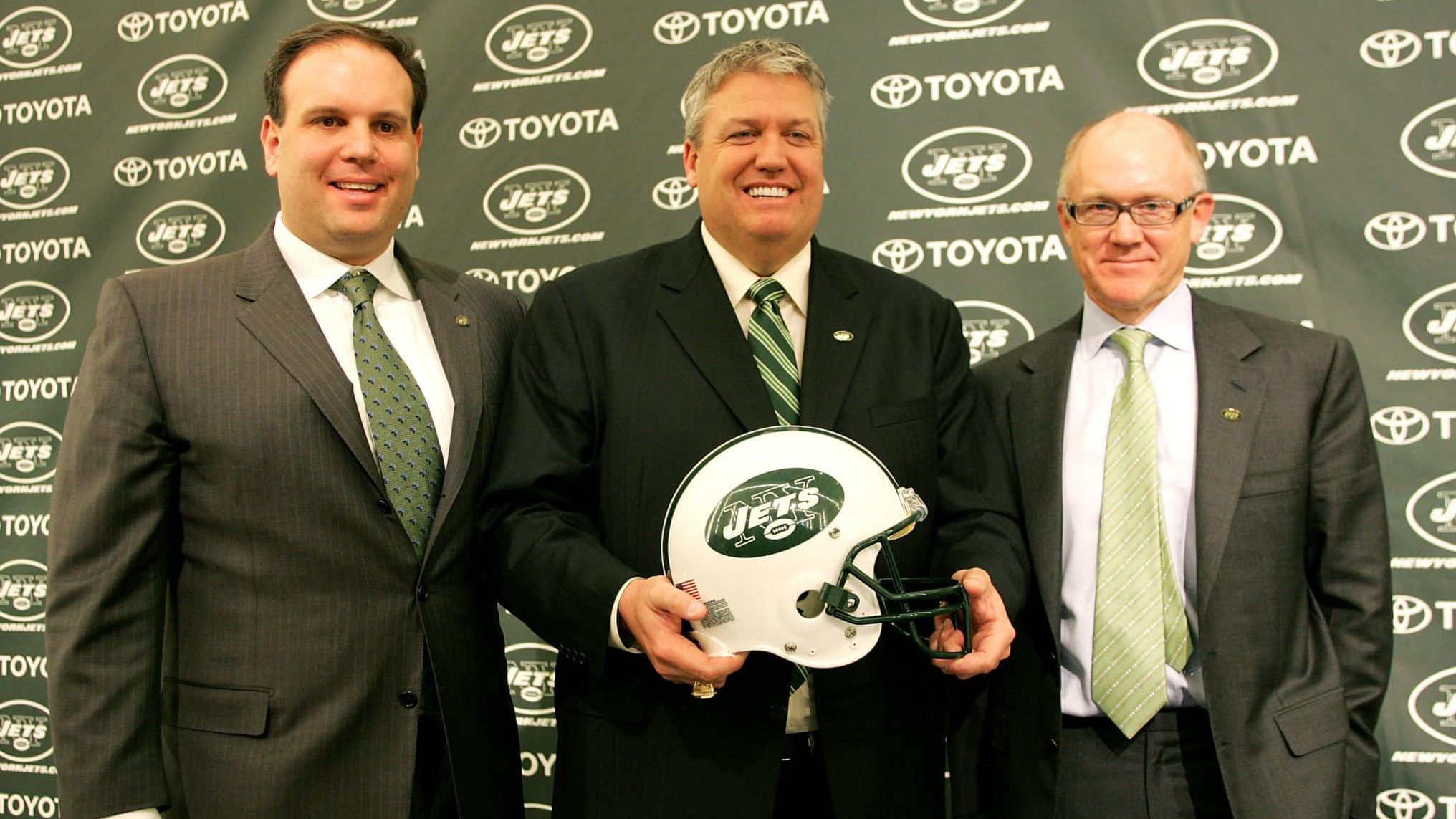 FLORHAM PARK, NJ - JANUARY 21: New York Jets Head Coach Rex Ryan (C) Owner Woody Johnson (R) and General Manager Mike Tannenbaum pose for a photo at a press conference naming Ryan as the new Head Coach of the New York Jets at the Atlantic Health Jets Training Center on January 21, 2009 in Florham Park, New Jersey.