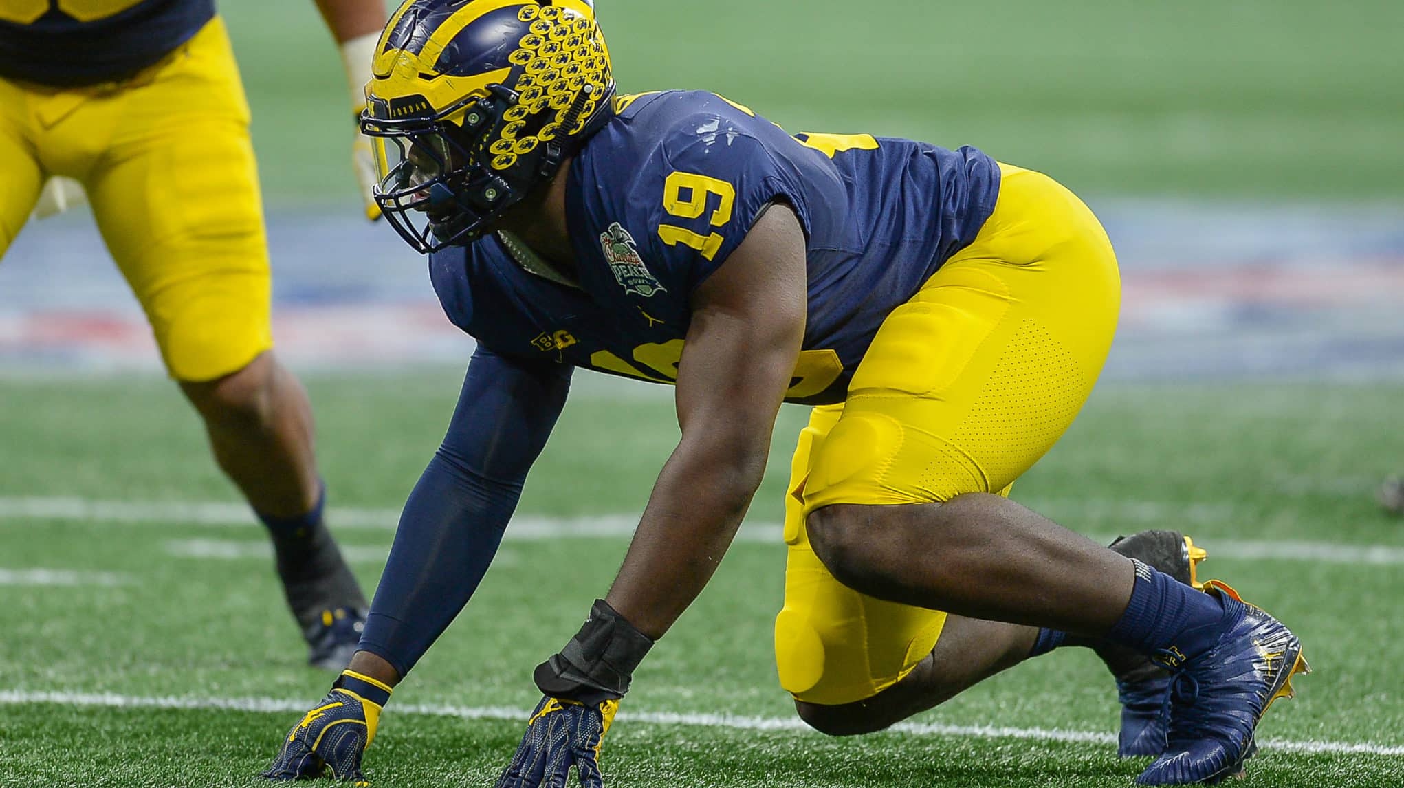 ATLANTA, GA DECEMBER 29: Michigan's Kwity Paye (19) prepares to rush the quarterback during the Chick-fil-A Peach Bowl between the Michigan Wolverines and the Florida Gators on December 29th, 2018 at Mercedes-Benz Stadium in Atlanta, GA.