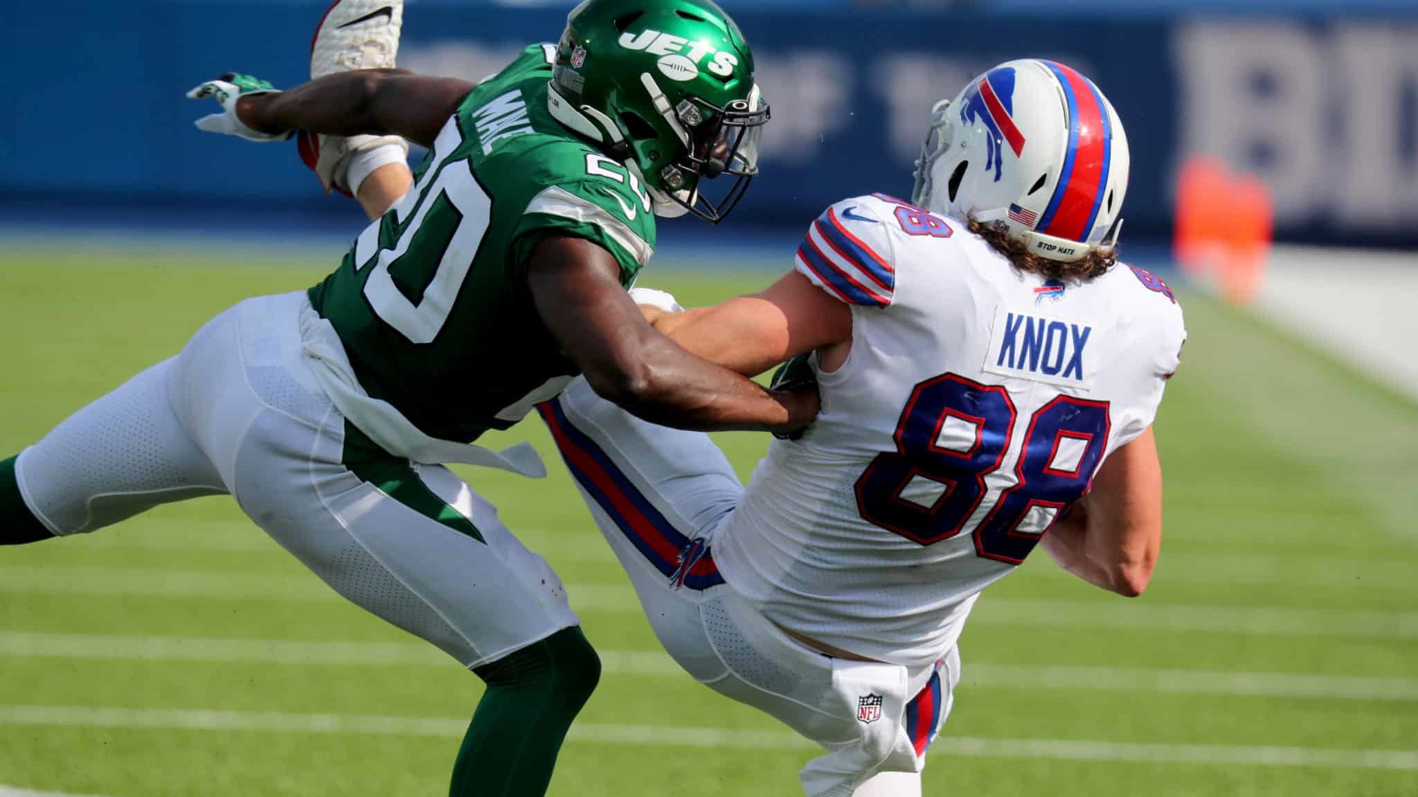 ORCHARD PARK, NY - SEPTEMBER 13: Dawson Knox #88 of the Buffalo Bills makes a catch as Marcus Maye #20 of the New York Jets makes the tackle during the second half at Bills Stadium on September 13, 2020 in Orchard Park, New York. Bills beat the Jets 27 to 17.