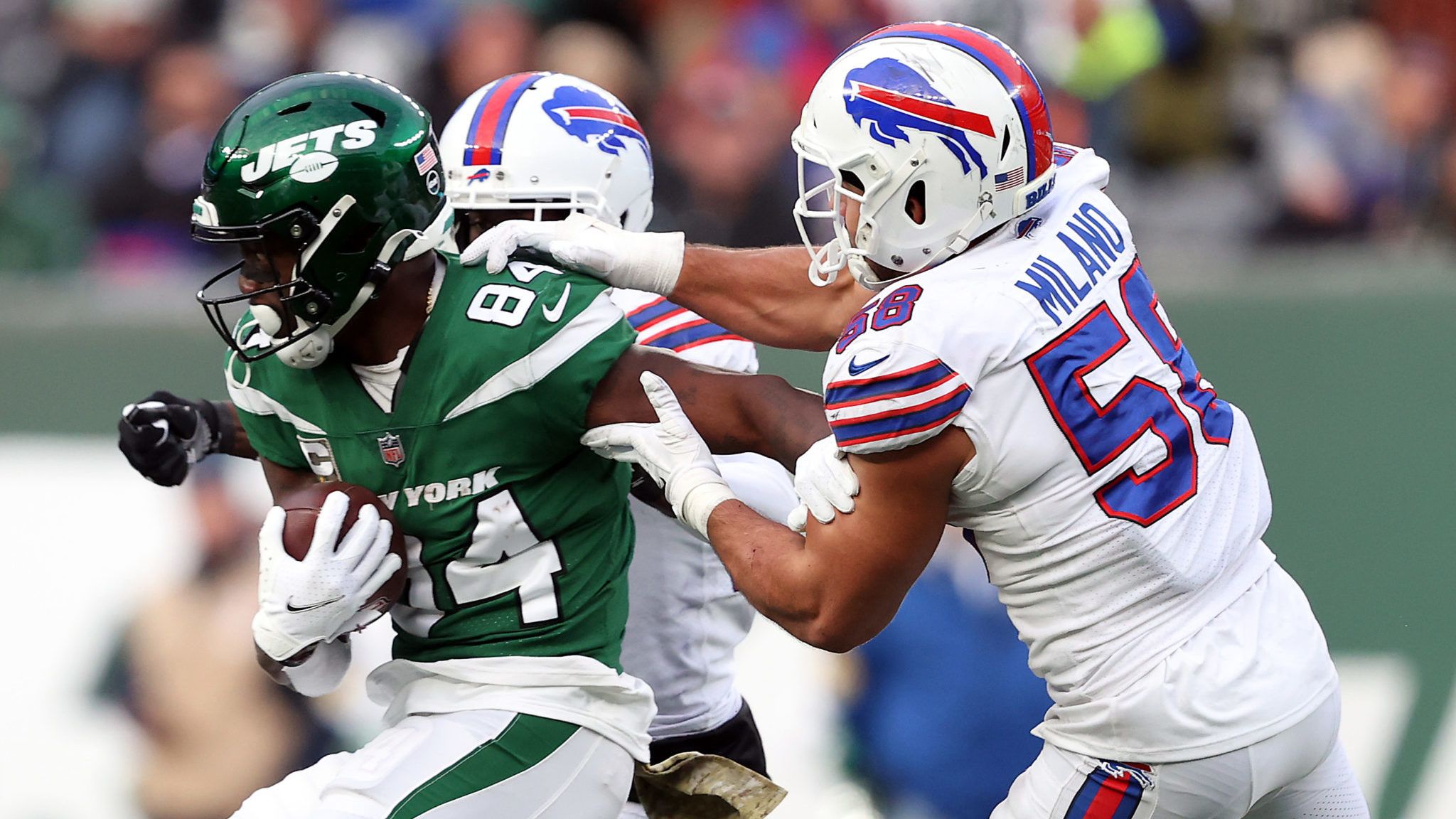 EAST RUTHERFORD, NEW JERSEY - NOVEMBER 14: Matt Milano #58 and Tre'Davious White #27 of the Buffalo Bills tackle Corey Davis #84 of the New York Jets after he makes catch in the fourth quarter at MetLife Stadium on November 14, 2021 in East Rutherford, New Jersey.