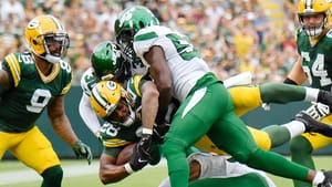 Jarrad Davis and Michael Carter II make a tackle for the NY Jets in their preseason win over the Green Bay Packers.