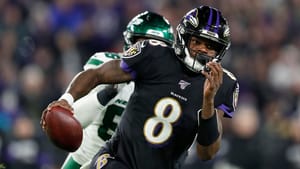 BALTIMORE, MARYLAND - DECEMBER 12: Quarterback Lamar Jackson #8 of the Baltimore Ravens scrambles against the defense of the New York Jets during the game at M&T Bank Stadium on December 12, 2019 in Baltimore, Maryland.