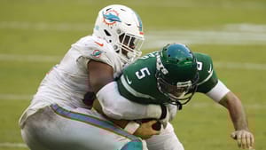 MIAMI GARDENS, FLORIDA - OCTOBER 18: Emmanuel Ogbah #91 of the Miami Dolphins tackles quarterback Joe Flacco #5 of the New York Jets for the sack during the second half of their game at Hard Rock Stadium on October 18, 2020 in Miami Gardens, Florida.