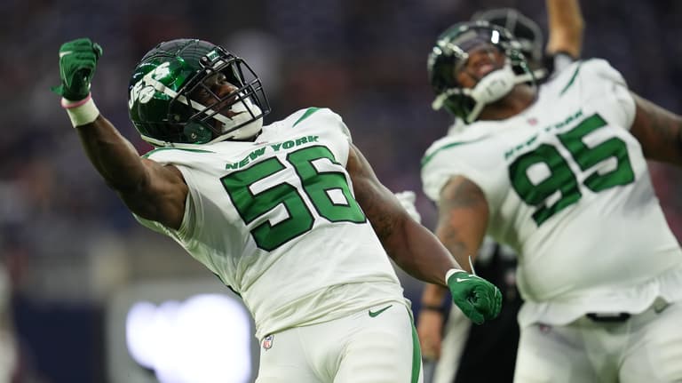 HOUSTON, TEXAS - NOVEMBER 28: Quincy Williams #56 of the New York Jets celebrates with defensive tackle Quinnen Williams (95) against the Houston Texans during an NFL game at NRG Stadium on November 28, 2021 in Houston, Texas.