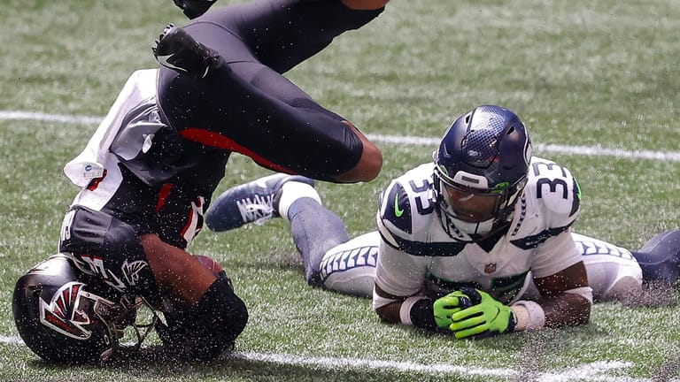 ATLANTA, GEORGIA - SEPTEMBER 13: Jamal Adams #33 of the Seattle Seahawks tackles Russell Gage #83 of the Atlanta Falcons after a reception in the first half at Mercedes-Benz Stadium on September 13, 2020 in Atlanta, Georgia.