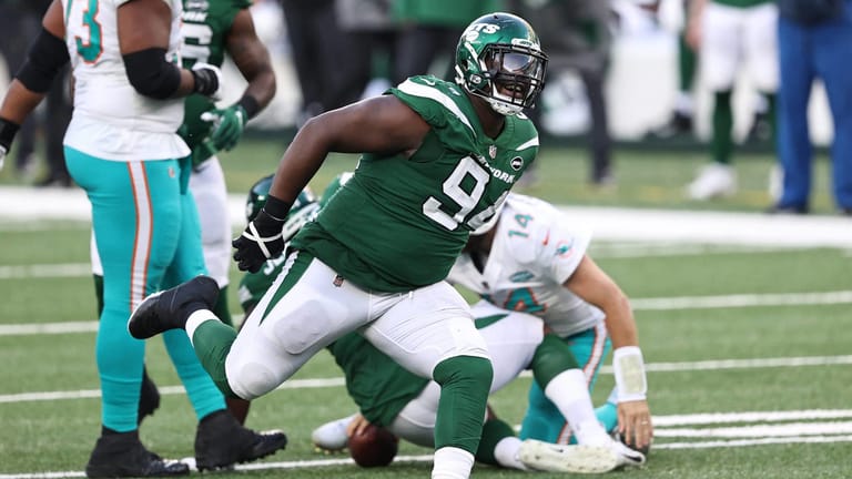 EAST RUTHERFORD, NEW JERSEY - NOVEMBER 29: Folorunso Fatukasi #94 of the New York Jets celebrates after a sack of Ryan Fitzpatrick #14 of the Miami Dolphins during their NFL game at MetLife Stadium on November 29, 2020 in East Rutherford, New Jersey.