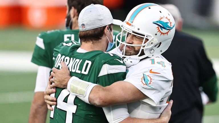 EAST RUTHERFORD, NEW JERSEY - NOVEMBER 29: Sam Darnold #14 of the New York Jets and Ryan Fitzpatrick #14 of the Miami Dolphins greet each other after their NFL game at MetLife Stadium on November 29, 2020 in East Rutherford, New Jersey.