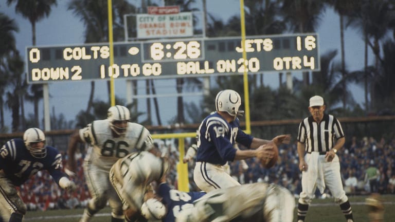 MIAMI - JANUARY 12: Baltimore Colts' Johnny Unitas #19 looks for a receiver as the New York Jets close in for a tackle during Super Bowl III at the Orange Bowl on January 12, 1969 in Miami, Florida. The Jets defeated the Colts 16-7.