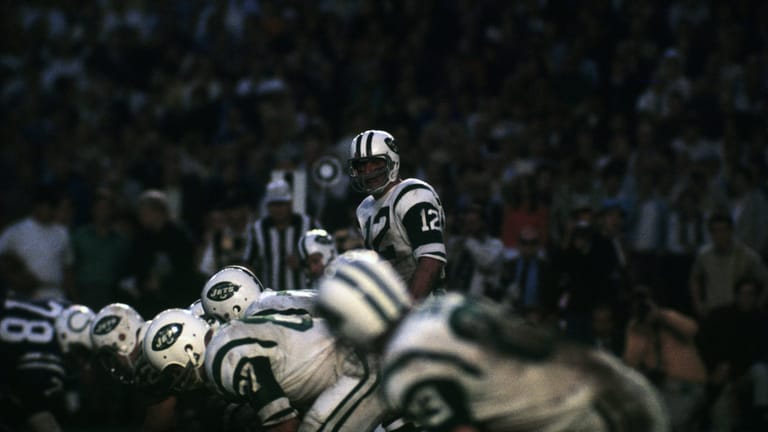 MIAMI, FL - JANUARY 12, 1969: Quarterback Joe Namath #12 of the New York Jets scans the defense as he prepares to call the signals at the line fo scrimmage during Super Bowl III on January 12, 1969 against the Baltimore Colts at the Orange Bowl in Miami, Florida. The Jets beat the Colts, 16-7. 196901012-125 1969