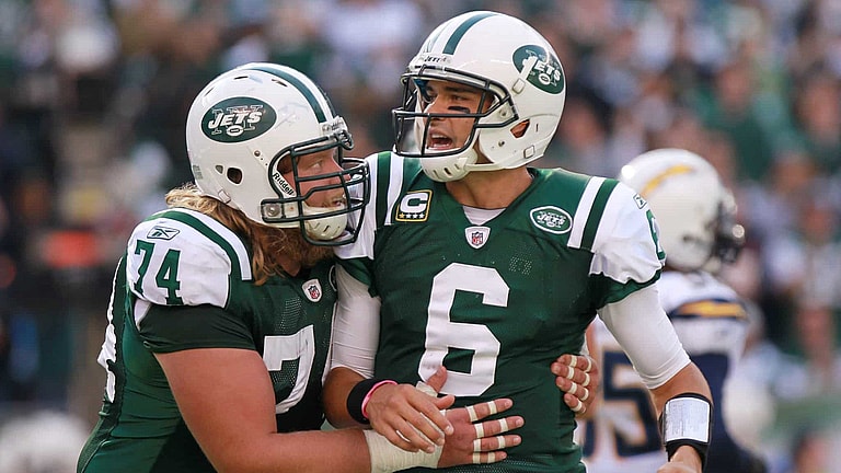 EAST RUTHERFORD, NJ - OCTOBER 23: Mark Sanchez #6 of the New York Jets is congratulated on a touchdown pass by teammate Nick Mangold #74 against the San Diego Chargers at MetLife Stadium on October 23, 2011 in East Rutherford, New Jersey.