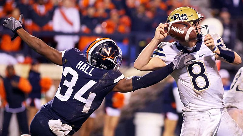 CHARLOTTESVILLE, VA - NOVEMBER 02: Bryce Hall #34 of the Virginia Cavaliers disrupts a pass by Kenny Pickett #8 of the Pittsburgh Panthers in the second half during a game at Scott Stadium on November 2, 2018 in Charlottesville, Virginia.