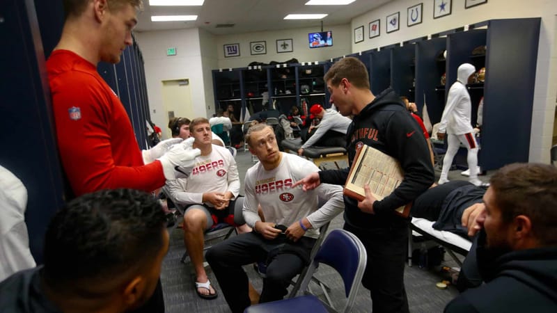 SEATTLE, WA - DECEMBER 29: Pass Game Coordinator Mike LaFleur and George Kittle #85 of the San Francisco 49ers talk in the locker room prior to the game against the Seattle Seahawks at CenturyLink Field on December 29, 2019 in Seattle, Washington. The 49ers defeated the Seahawks 26-21.