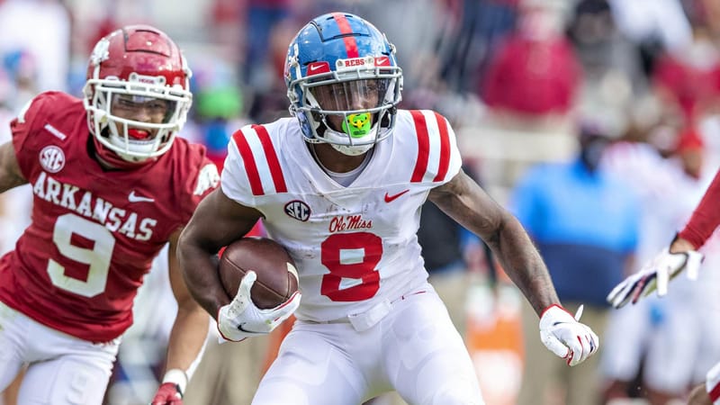 FAYETTEVILLE, AR - OCTOBER 17: Elijah Moore #8 of the Mississippi Rebels runs past Greg Brooks Jr. #9 of the Arkansas Razorbacks at Razorback Stadium on October 17, 2020 in Fayetteville, Arkansas. The Razorbacks defeated the Rebels 33-21.