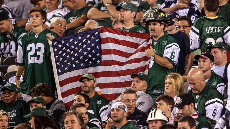 NY Jets fans hold an American Flag at MetLife Stadium during a 2011 game against the Dallas Cowboys.