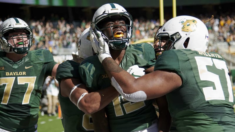 WACO, TX - NOVEMBER 3: Denzel Mims #15 of the Baylor Bears celebrates with his teammates after scoring the game winning touchdown on a 6 yard reception against the Oklahoma State Cowboys during the second half of an NCAA football game at McLane Stadium on November 3, 2018 in Waco, Texas.