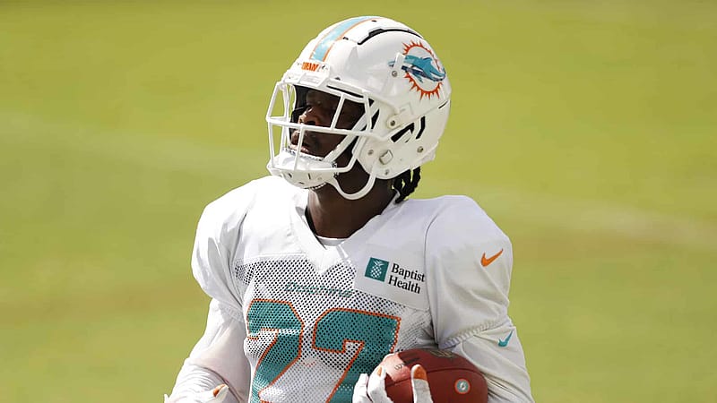 DAVIE, FLORIDA - AUGUST 18: Kalen Ballage #27 of the Miami Dolphins runs through a drill during training camp at Baptist Health Training Facility at Nova Southern University on August 18, 2020 in Davie, Florida.