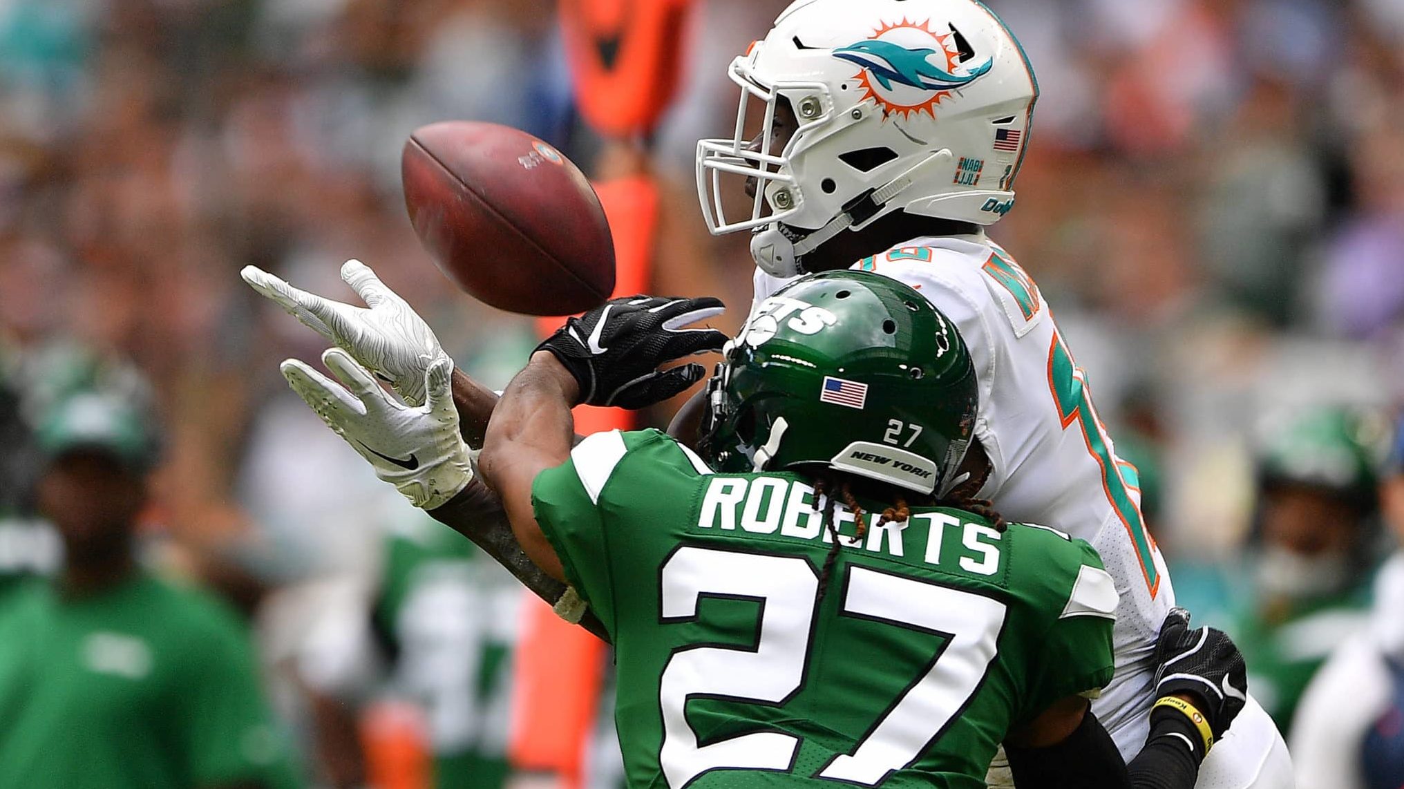 MIAMI, FLORIDA - NOVEMBER 03: Preston Williams #18 of the Miami Dolphins makes the catch against Darryl Roberts #27 of the New York Jets in the first quarter at Hard Rock Stadium on November 03, 2019 in Miami, Florida.