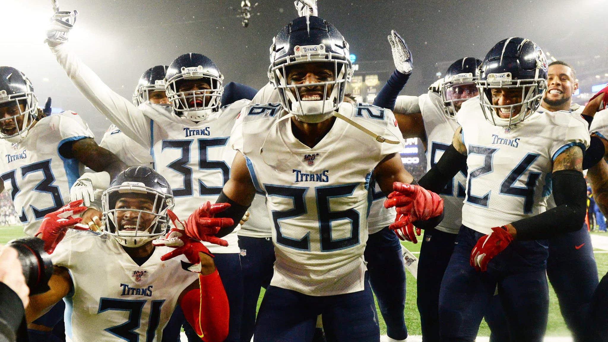 FOXBOROUGH, MASSACHUSETTS - JANUARY 04: Logan Ryan #26 of the Tennessee Titans celebrates his touchdown with teammates against the New England Patriots in the fourth quarter of the AFC Wild Card Playoff game at Gillette Stadium on January 04, 2020 in Foxborough, Massachusetts.