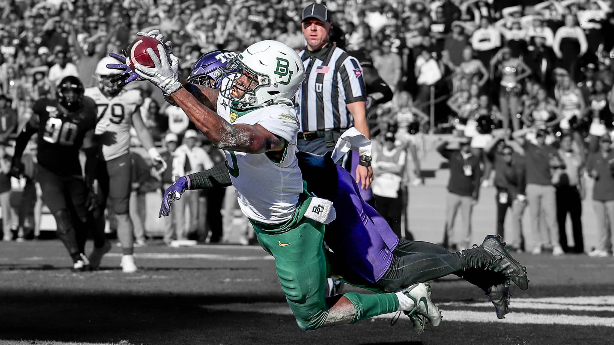 FORT WORTH, TEXAS - NOVEMBER 09: Denzel Mims #5 of the Baylor Bears tries to hang on to the ball on a two-point attempt against the TCU Horned Frogs in the third overtime period at Amon G. Carter Stadium on November 09, 2019 in Fort Worth, Texas.