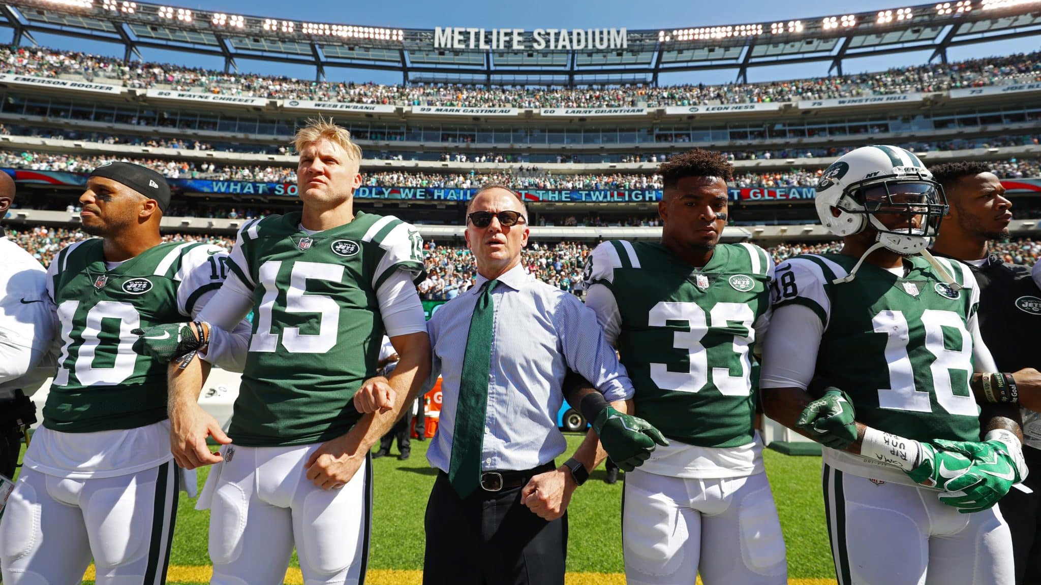 EAST RUTHERFORD, NJ - SEPTEMBER 24: Jermaine Kearse #10, Josh McCown #15, Jamal Adams #33, ArDarius Stewart #18 and Christopher Johnson CEO of the New York Jets stand in unison with his team during the National Anthem prior to an NFL game against the Miami Dolphins at MetLife Stadium on September 24, 2017 in East Rutherford, New Jersey.