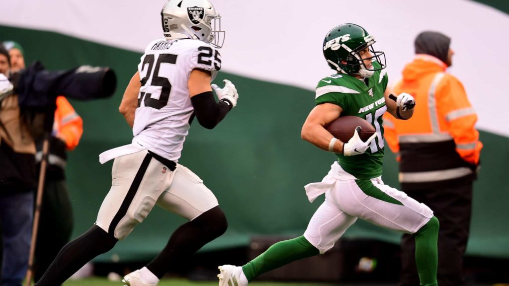 EAST RUTHERFORD, NEW JERSEY - NOVEMBER 24: Braxton Berrios #10 of the New York Jets runs the ball past Erik Harris #25 of the Oakland Raiders during the second half of their game at MetLife Stadium on November 24, 2019 in East Rutherford, New Jersey.
