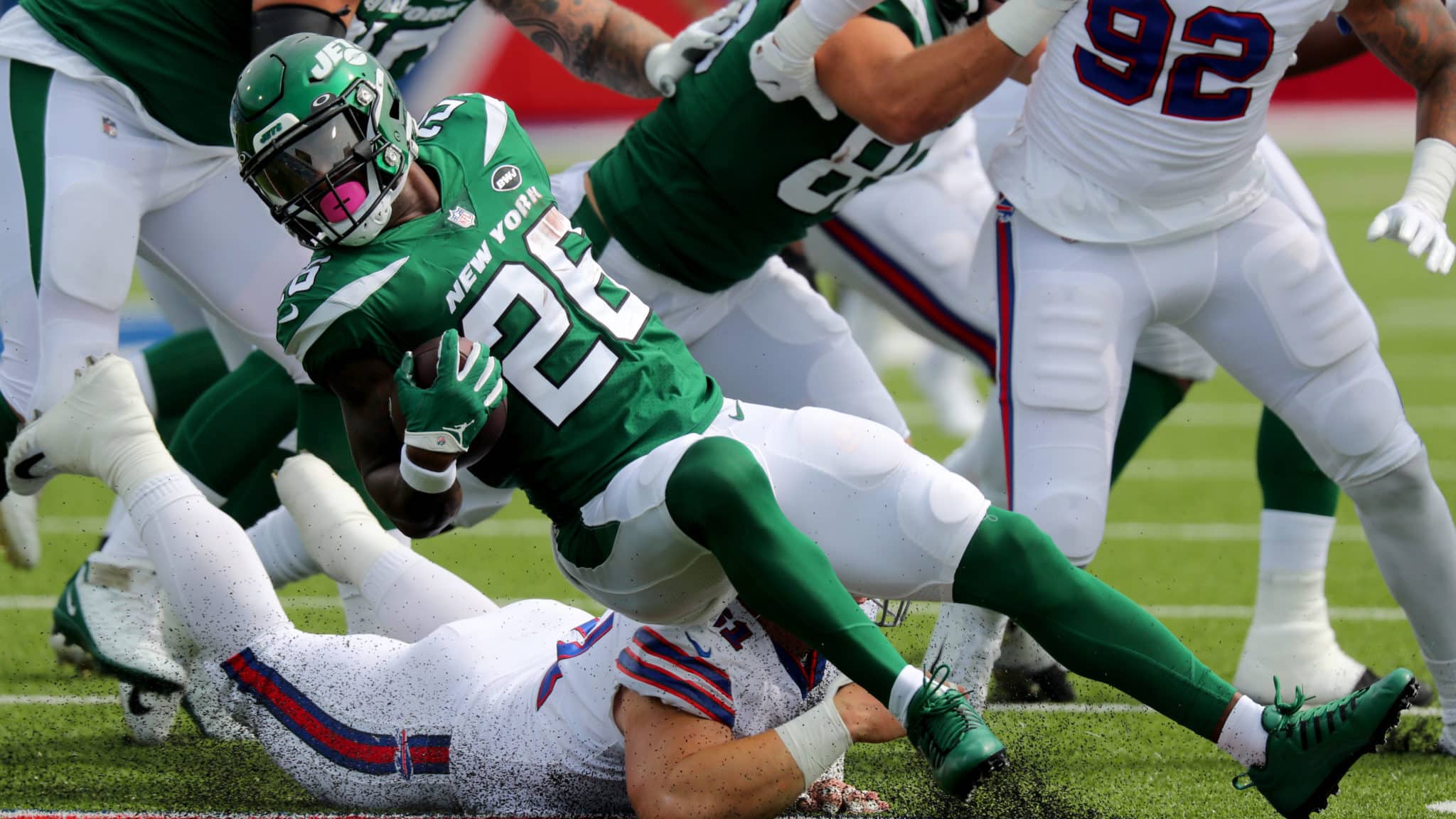 ORCHARD PARK, NY - SEPTEMBER 13: Justin Zimmer #61 of the Buffalo Bills dives to make a tackle on Le'Veon Bell #26 of the New York Jets during the first quarter at Bills Stadium on September 13, 2020 in Orchard Park, New York.