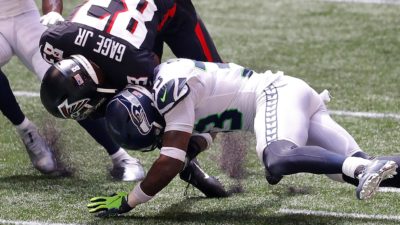 ATLANTA, GEORGIA - SEPTEMBER 13: Jamal Adams #33 of the Seattle Seahawks tackles Russell Gage #83 of the Atlanta Falcons after a reception in the first half at Mercedes-Benz Stadium on September 13, 2020 in Atlanta, Georgia.