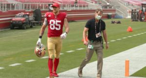 SANTA CLARA, CALIFORNIA - SEPTEMBER 13: George Kittle #85 of the San Francisco 49ers walks off the field with trainer Tim McAdams just before halftime of their game against the Arizona Cardinals at Levi's Stadium on September 13, 2020 in Santa Clara, California.