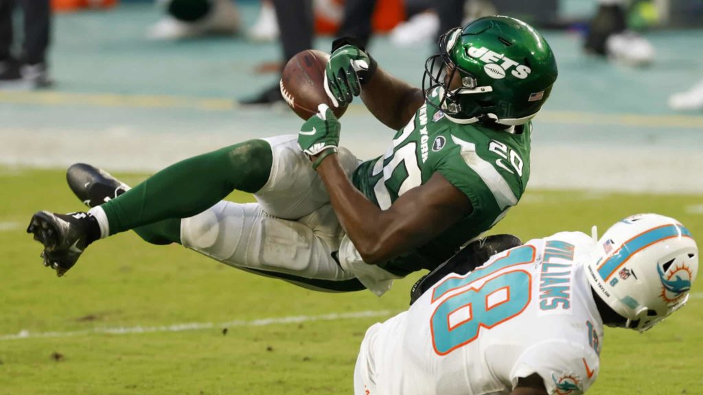 MIAMI GARDENS, FLORIDA - OCTOBER 18: Marcus Maye #20 of the New York Jets intercepts a pass meant for Preston Williams #18 of the Miami Dolphins during the second half of their game at Hard Rock Stadium on October 18, 2020 in Miami Gardens, Florida.