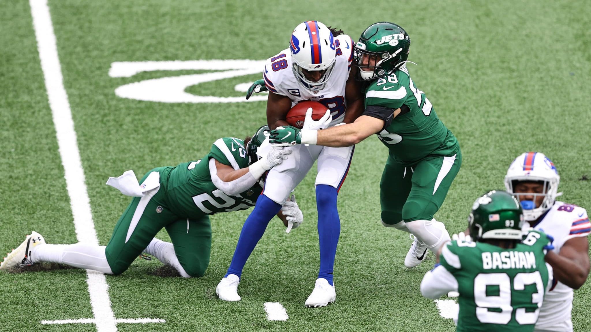 EAST RUTHERFORD, NEW JERSEY - OCTOBER 25: Ty Johnson #25 and Bryce Hager #58 of the New York Jets tackle Andre Roberts #18 of the Buffalo Bills during a kickoff return in the second quarter of the game at MetLife Stadium on October 25, 2020 in East Rutherford, New Jersey.