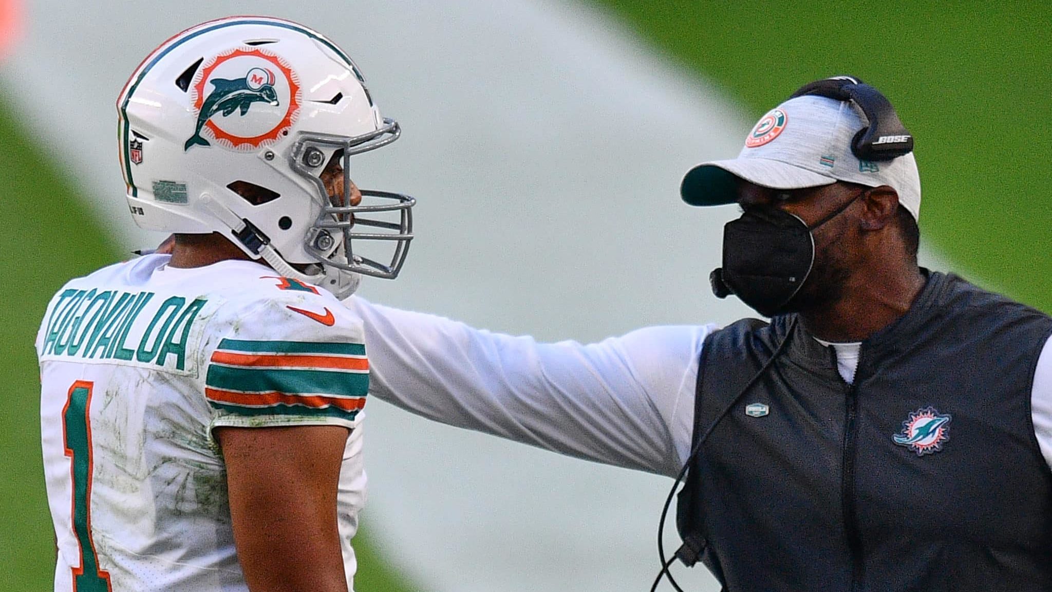 MIAMI GARDENS, FLORIDA - NOVEMBER 15: Head Coach Brian Flores of the Miami Dolphins speaks with Tua Tagovailoa #1 during the game against the Los Angeles Chargers at Hard Rock Stadium on November 15, 2020 in Miami Gardens, Florida.