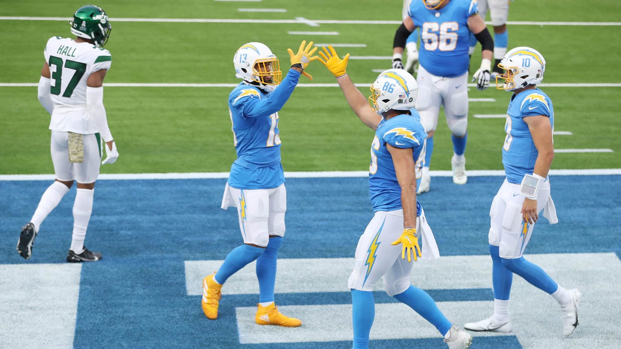 INGLEWOOD, CALIFORNIA - NOVEMBER 22: Hunter Henry #86 high-fives Keenan Allen #13 of the Los Angeles Chargers after Henry caught a touchdown pass during the first half against the New York Jets at SoFi Stadium on November 22, 2020 in Inglewood, California.