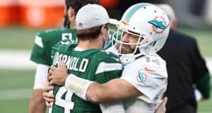 EAST RUTHERFORD, NEW JERSEY - NOVEMBER 29: Sam Darnold #14 of the New York Jets and Ryan Fitzpatrick #14 of the Miami Dolphins greet each other after their NFL game at MetLife Stadium on November 29, 2020 in East Rutherford, New Jersey.