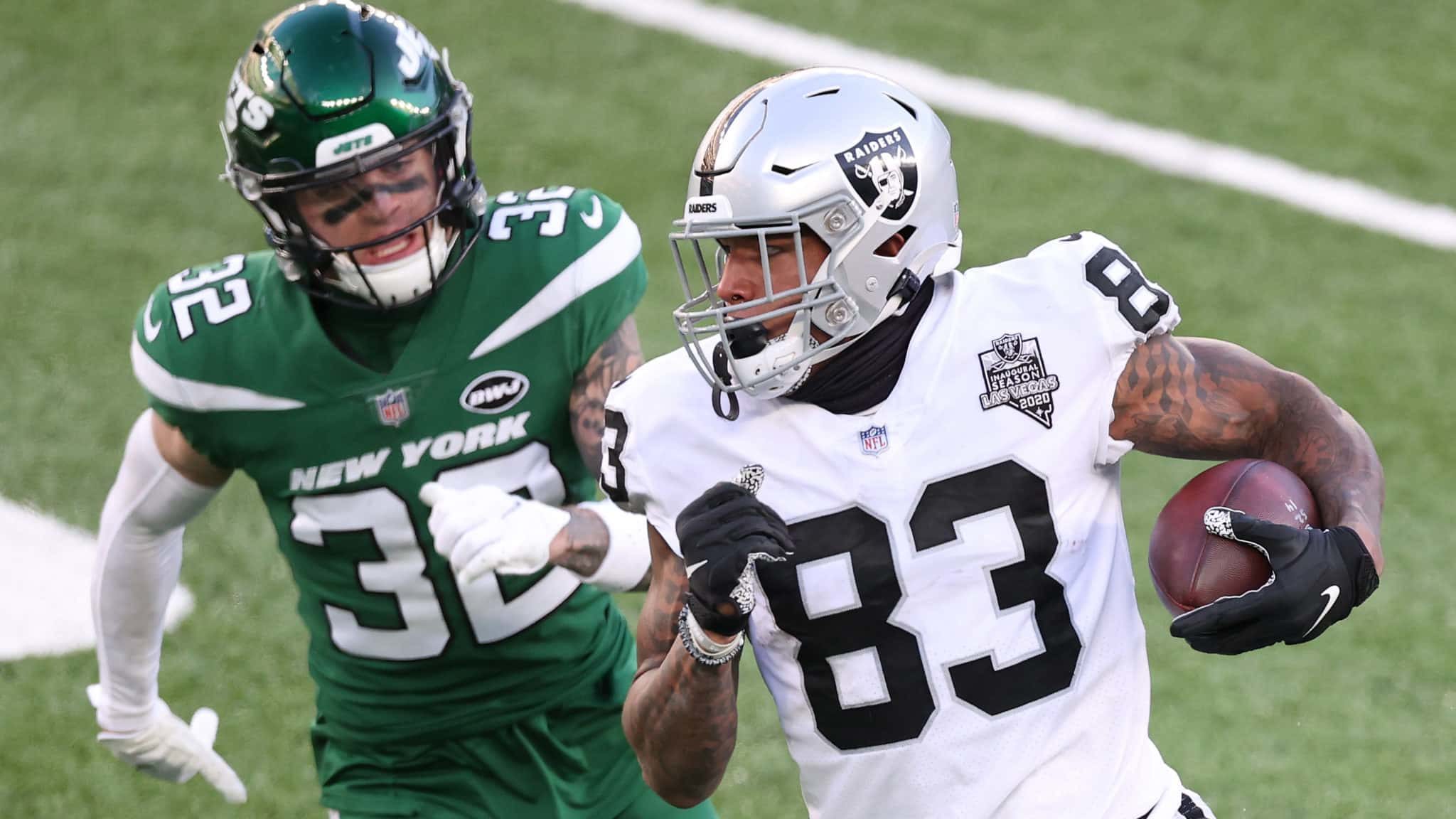 EAST RUTHERFORD, NEW JERSEY - DECEMBER 06: Darren Waller #83 of the Las Vegas Raiders carries the ball as Ashtyn Davis #32 of the New York Jets gives chase during the second half at MetLife Stadium on December 06, 2020 in East Rutherford, New Jersey.