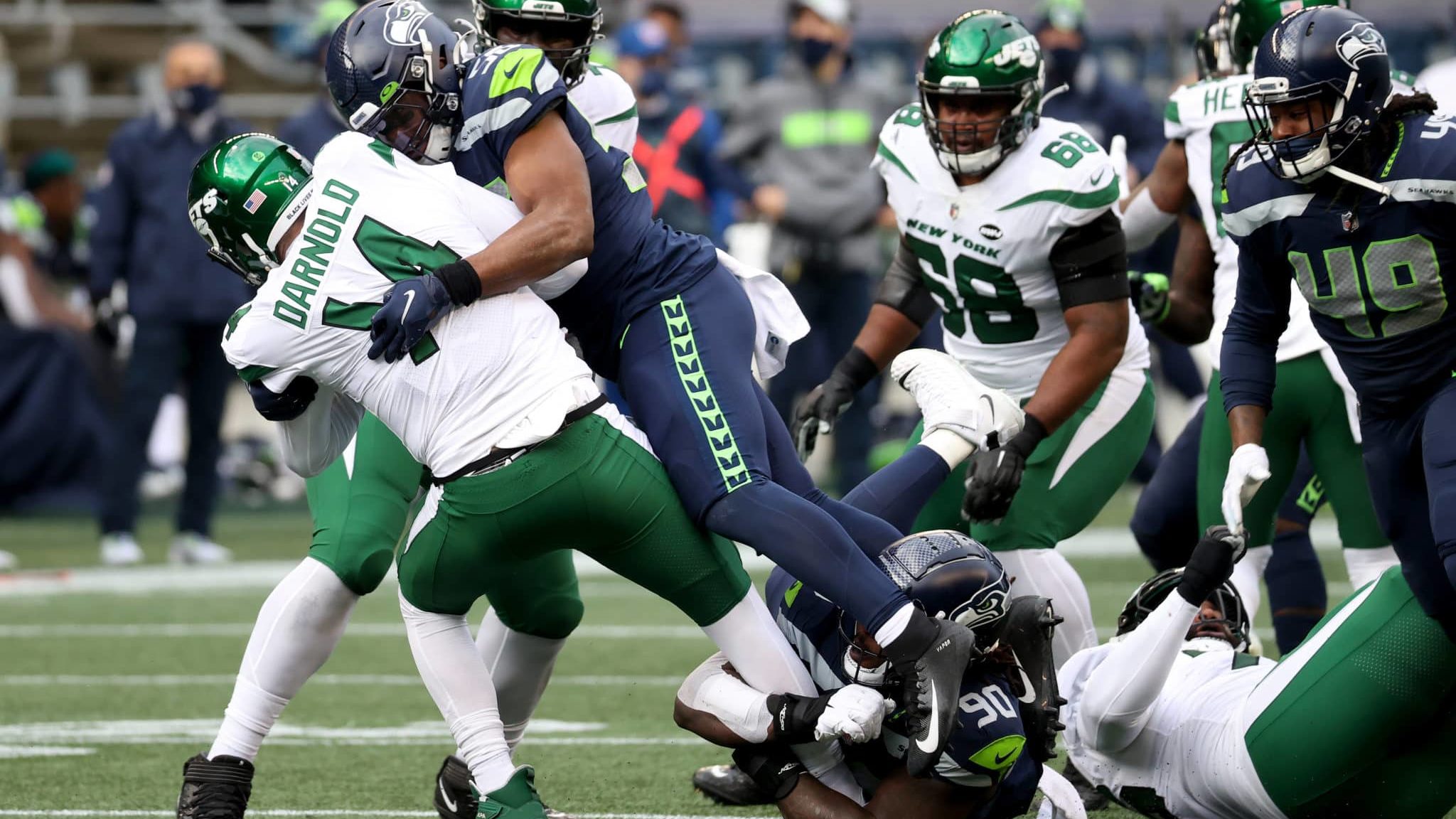 SEATTLE, WASHINGTON - DECEMBER 13: Jordyn Brooks #56 of the Seattle Seahawks sacks Sam Darnold #14 of the New York Jets but the play was called back during the second quarter in the game at Lumen Field on December 13, 2020 in Seattle, Washington.