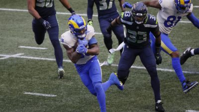 SEATTLE, WASHINGTON - JANUARY 09: Running back Cam Akers #23 of the Los Angeles Rams rushes for a touchdown over strong safety Jamal Adams #33 of the Seattle Seahawks during the second quarter of the NFC Wild Card Playoff game at Lumen Field on January 09, 2021 in Seattle, Washington.