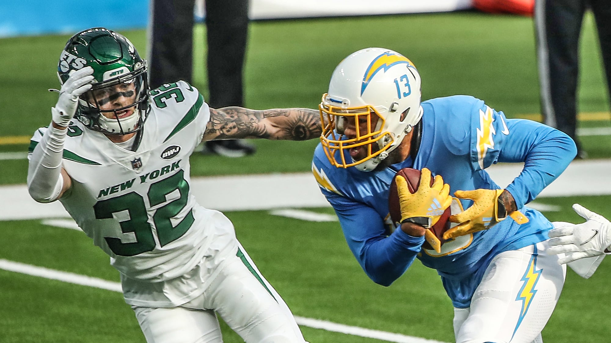 INGLEWOOD, CALIFORNIA - NOVEMBER 22: Keenan Allen #13 of the Los Angeles Chargers carries the ball as Ashtyn Davis #32 and Harvey Langi #44 of the New York Jets defend during the first half at SoFi Stadium on November 22, 2020 in Inglewood, California.