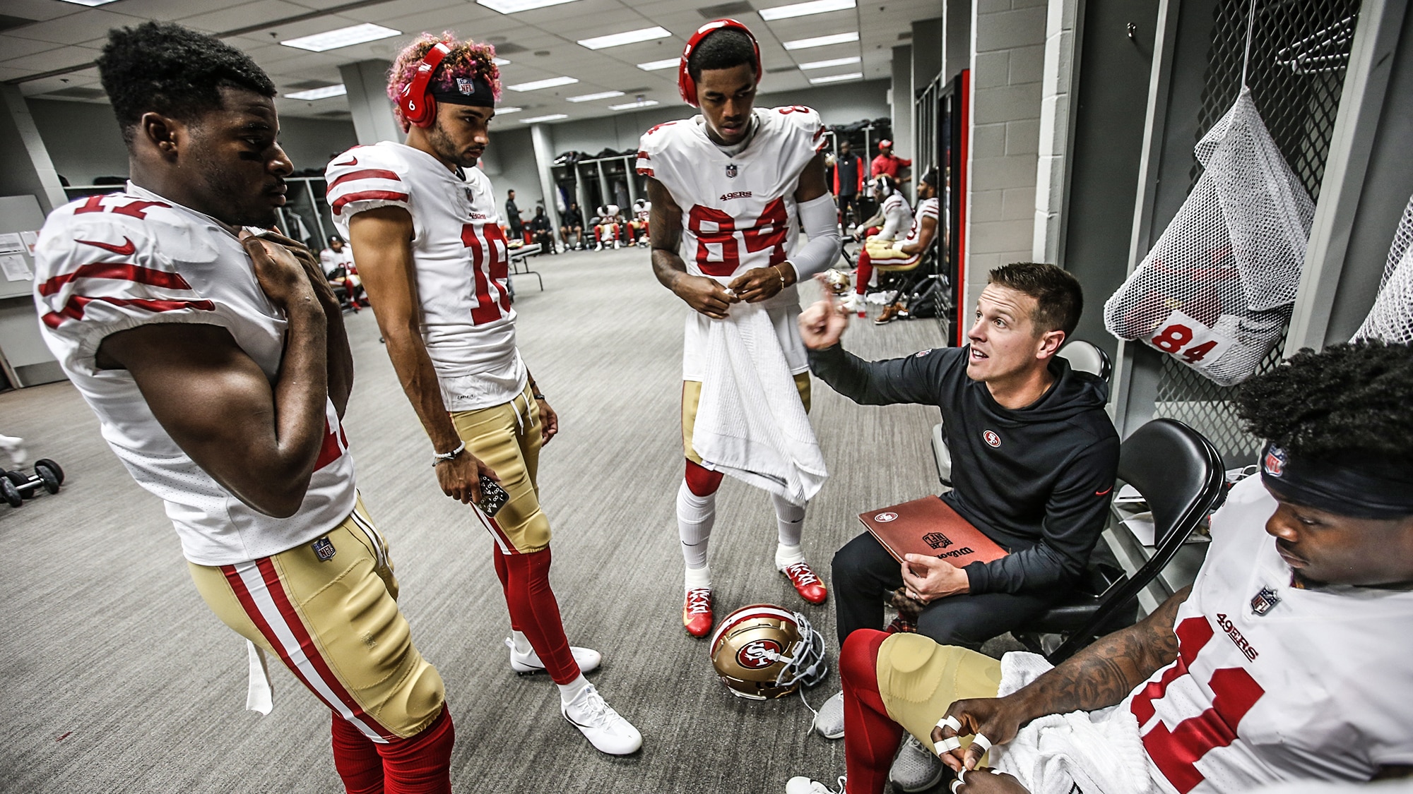 GLENDALE, AZ - OCTOBER 28: Wide Receivers/Passing Game Specialist Mike LaFleur of the San Francisco 49ers Victor Bolden Jr. #17, Dante Pettis #18, Kendrick Bourne #84 and Marquise Goodwin #11 in the locker room prior to the game against the Arizona Cardinals at State Farm Stadium on October 28, 2018 in Glendale, Arizona. The Cardinals defeated the 49ers 18-15.
