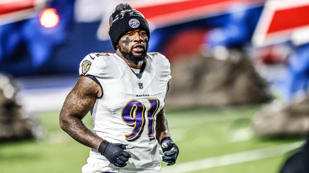 ORCHARD PARK, NEW YORK - JANUARY 16: Yannick Ngakoue #91 of the Baltimore Ravens runs on the field prior to an AFC Divisional Playoff game against the Buffalo Bills at Bills Stadium on January 16, 2021 in Orchard Park, New York.