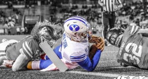 HOUSTON, TEXAS - OCTOBER 16: Zach Wilson #1 of the BYU Cougars is tackled near the goal line by Grant Stuard #0 of the Houston Cougars and Gervarrius Owens #32 in the first half at TDECU Stadium on October 16, 2020 in Houston, Texas.