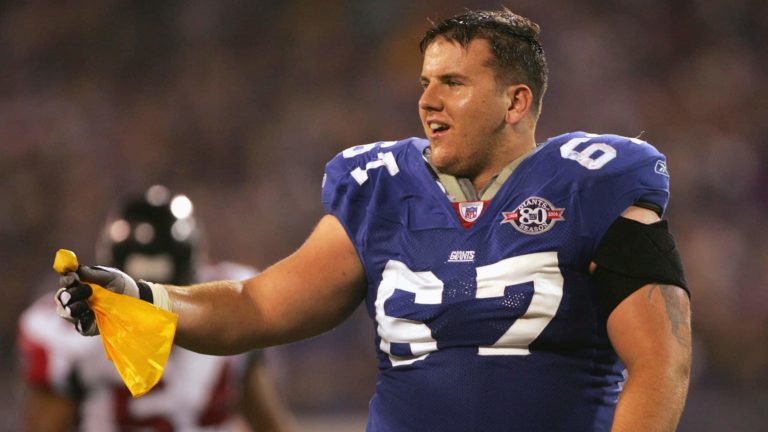 EAST RUTHERFORD, NJ - NOVEMBER 21: Guard Chris Snee #67 of the New York Giants looses his helmet and catches the flag on a penalty against the Atlanta Falcons in the third quarter at Giants Stadium on November 21, 2004 in East Rutherford, New Jersey. The Falcons defeated the Giants 14-10.
