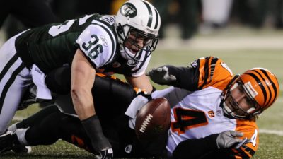 EAST RUTHERFORD, NJ - JANUARY 03: Quarterback J.T. O'Sullivan #4 of the Cincinnati Bengals reachs for the ball against Jim Leonhard #36 of the New York Jets in the second half of the game at Giants Stadium on January 3, 2010 in East Rutherford, New Jersey. The Jets defeated the Bengals 37-0.