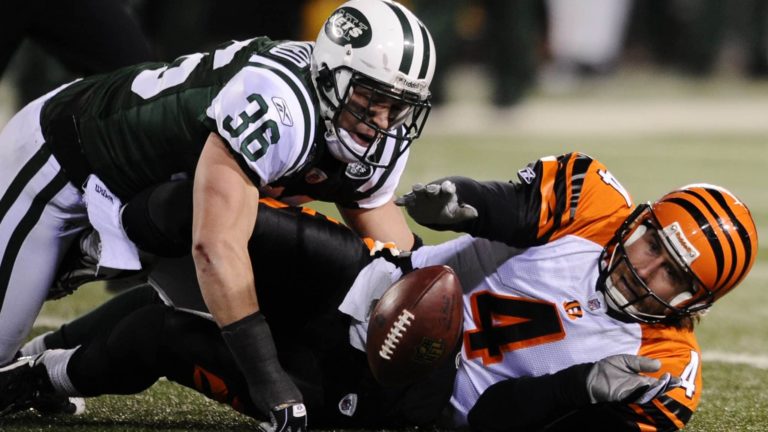 EAST RUTHERFORD, NJ - JANUARY 03: Quarterback J.T. O'Sullivan #4 of the Cincinnati Bengals reachs for the ball against Jim Leonhard #36 of the New York Jets in the second half of the game at Giants Stadium on January 3, 2010 in East Rutherford, New Jersey. The Jets defeated the Bengals 37-0.
