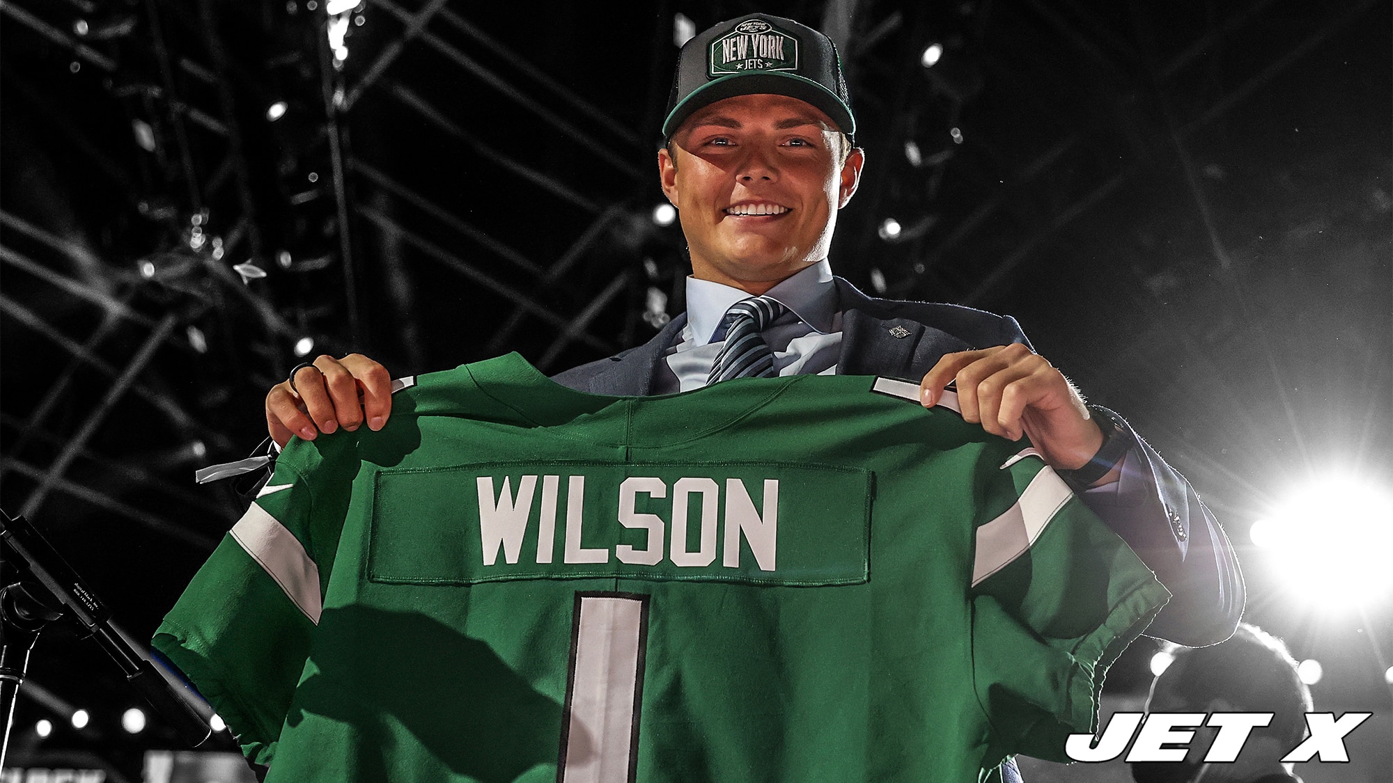 CLEVELAND, OHIO - APRIL 29: Zach Wilson holds a jersey onstage after being drafted second by the New York Jets during round one of the 2021 NFL Draft at the Great Lakes Science Center on April 29, 2021 in Cleveland, Ohio.