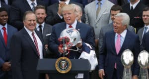 WASHINGTON, DC - APRIL 19: New England Patriots Head Coach Bill Belichick (L) and team owner Robert Kraft (R) present a football helmet to U.S. President Donald Trump during a celebration of the team's Super Bowl victory on the South Lawn at the White House April 19, 2017 in Washington, DC. It was the team's fifth Super Bowl victory since 1960.