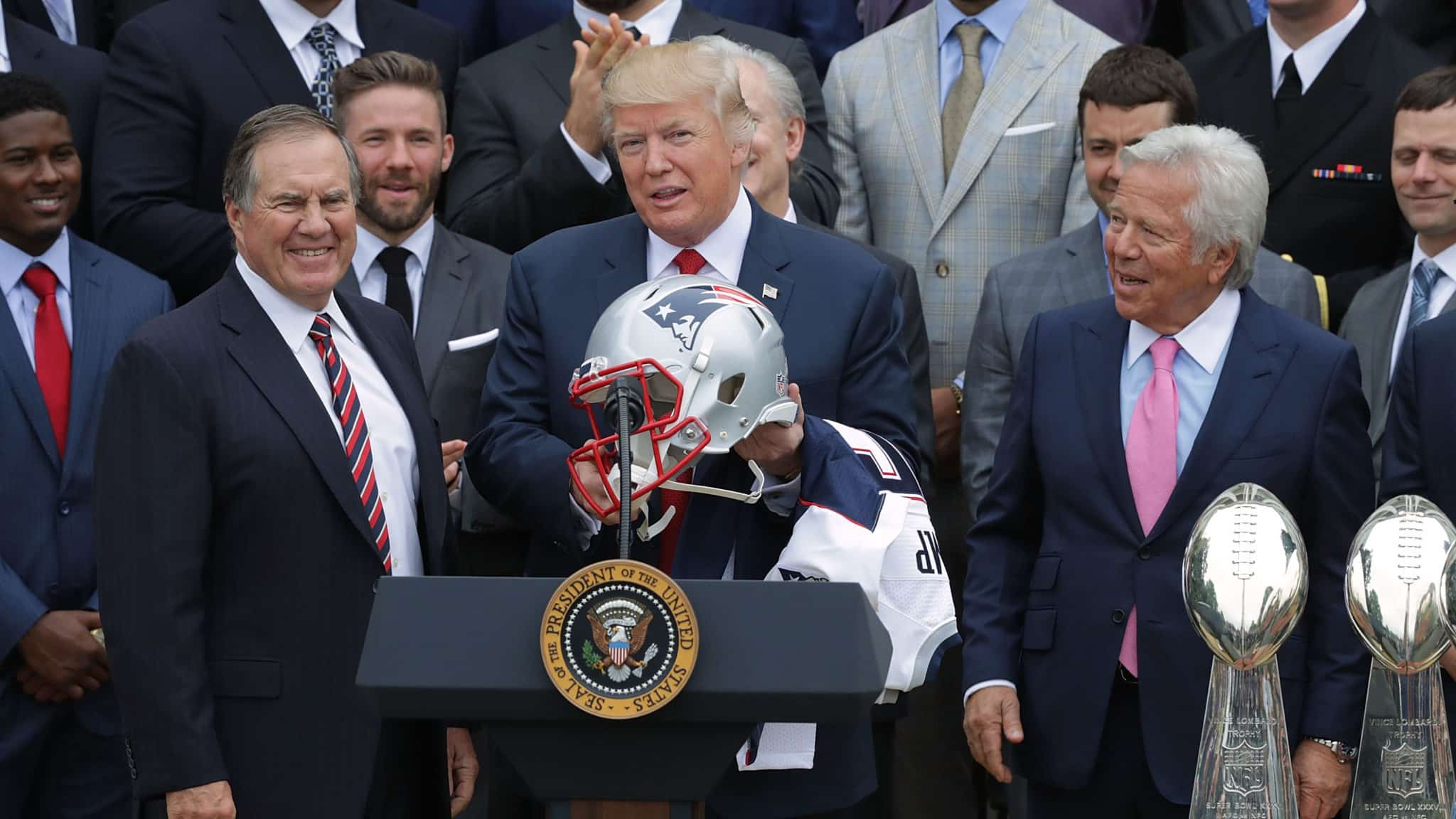 WASHINGTON, DC - APRIL 19: New England Patriots Head Coach Bill Belichick (L) and team owner Robert Kraft (R) present a football helmet to U.S. President Donald Trump during a celebration of the team's Super Bowl victory on the South Lawn at the White House April 19, 2017 in Washington, DC. It was the team's fifth Super Bowl victory since 1960.